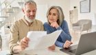 Middle,Aged,Senior,Old,Couple,Holding,Documents,Reading,Paper,Bills